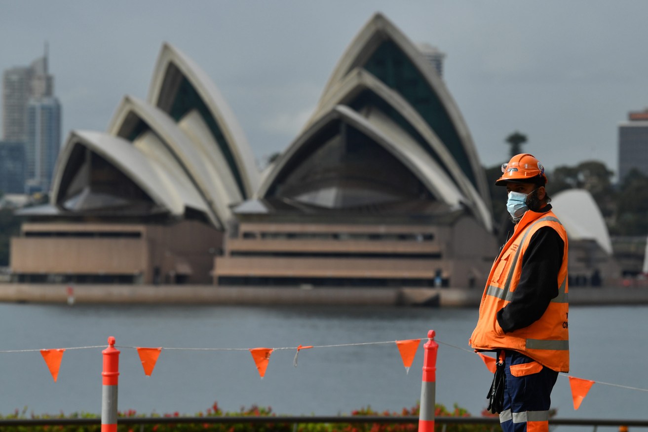 A workers seen at a construction site in front of the Sydney Opera House in Sydney, Monday, September 27, 2021. (AAP Image/Joel Carrett)