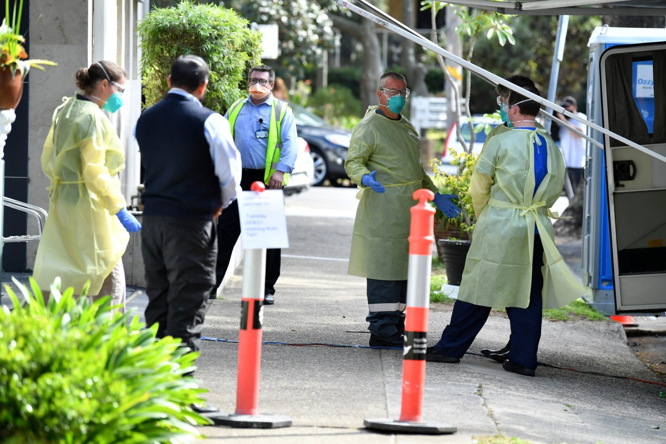 Workers wearing personal protective equipment at the Manly Waves Studio and Apartments in Sydney, Wednesday, September 29, 2021 (AAP Image/Joel Carrett).