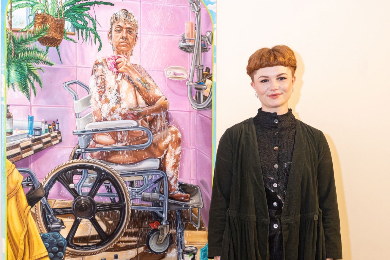 Centre for Creative Health Art Prize winner Jasmine Crisp with her winning portrait ‘They had to share (a portrait of Ruby)’. Photo: Andrew Beveridge
