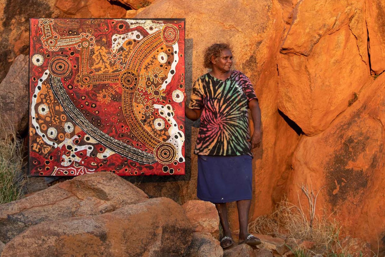 Pauline Wangin with her work 'Kapi Tjukula'; image courtesy the artist and Mimili Maku Arts. Photo: Meg Hansen