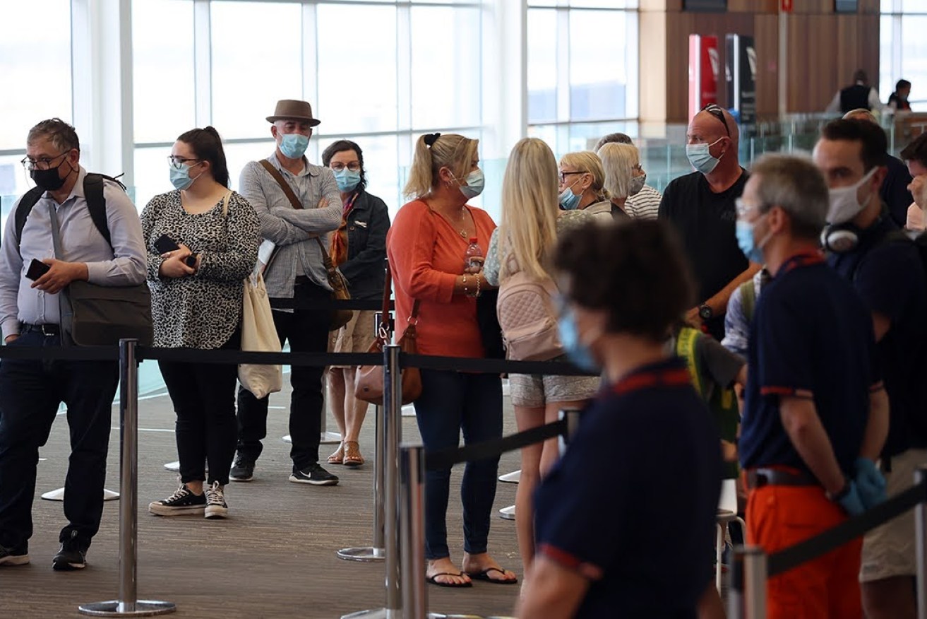 Masked travellers at Adelaide Airport. Photo: Tony Lewis/InDaily