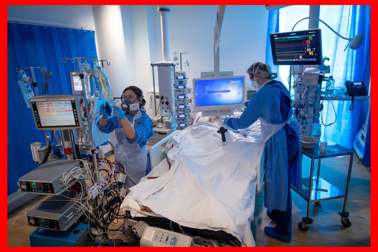 An extracorporeal membrane oxygenation (ECMO) machine and specialist staff with a COVID-19 patient. Photo: Joe Giddens/PA Wire