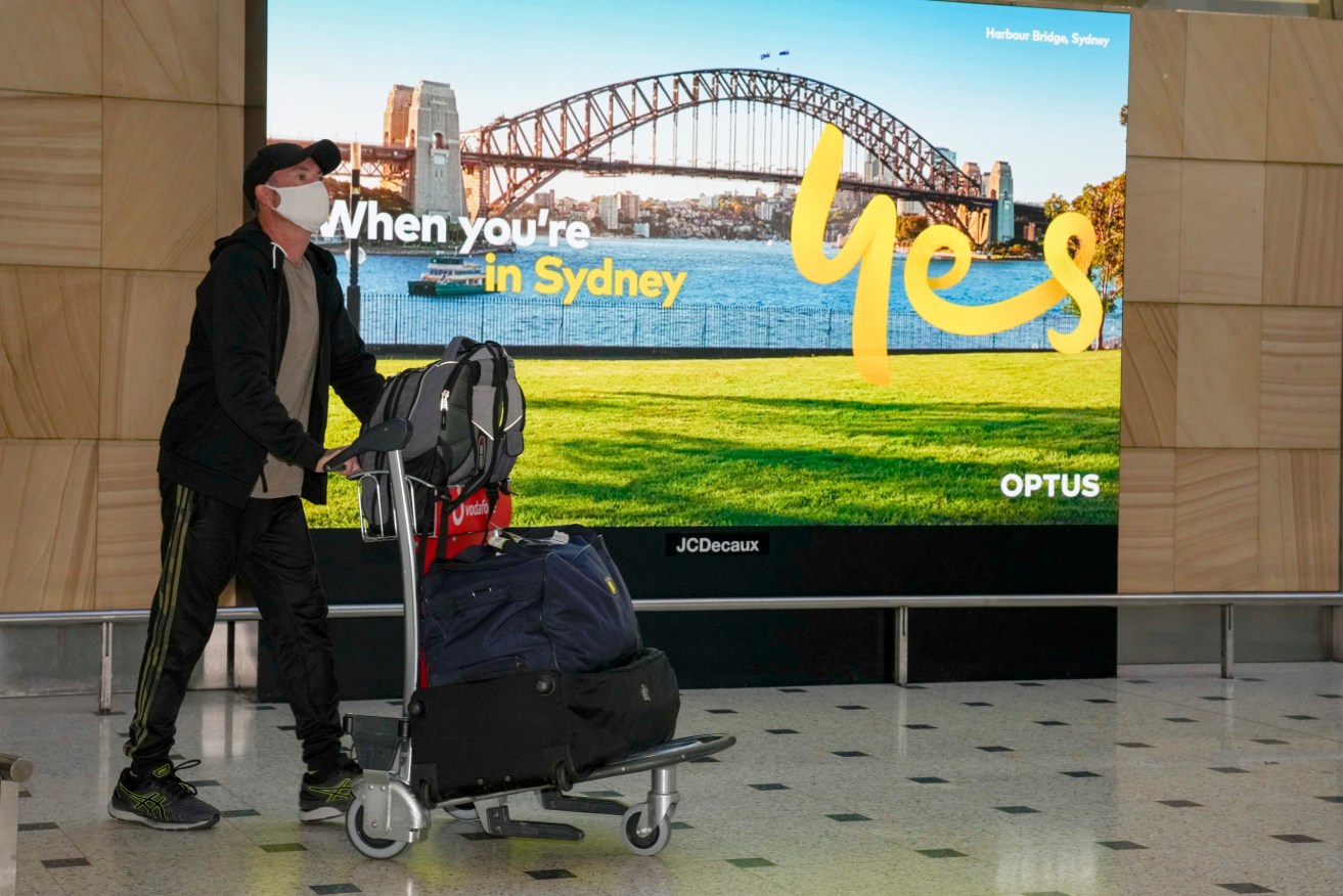 Passengers arrive at Sydney Airport on Monday. Photo: AP/Mark Baker