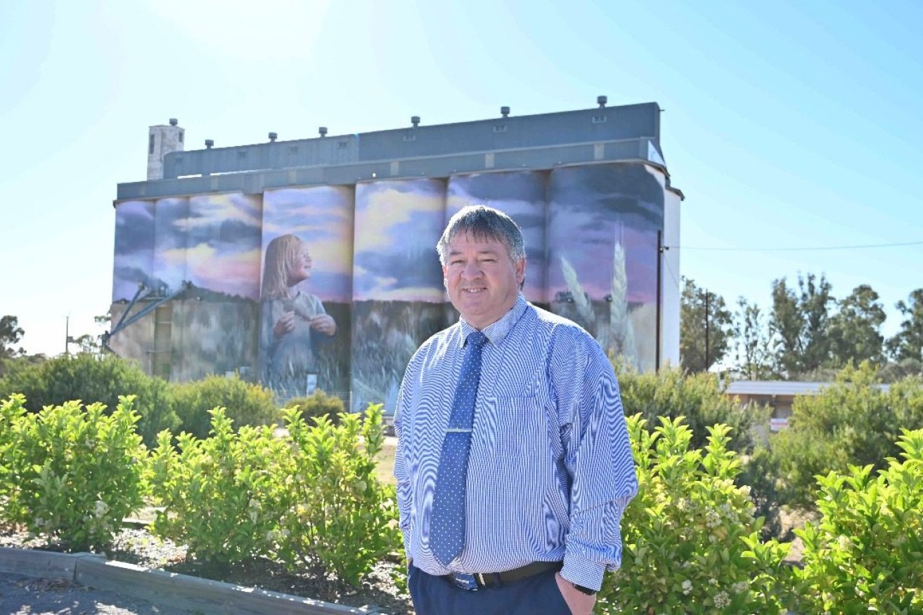 Kimba Mayor Dean Johnson in front of what has become iconic silo art that brings visitors off the highway and into the town. Photo: Belinda Willis