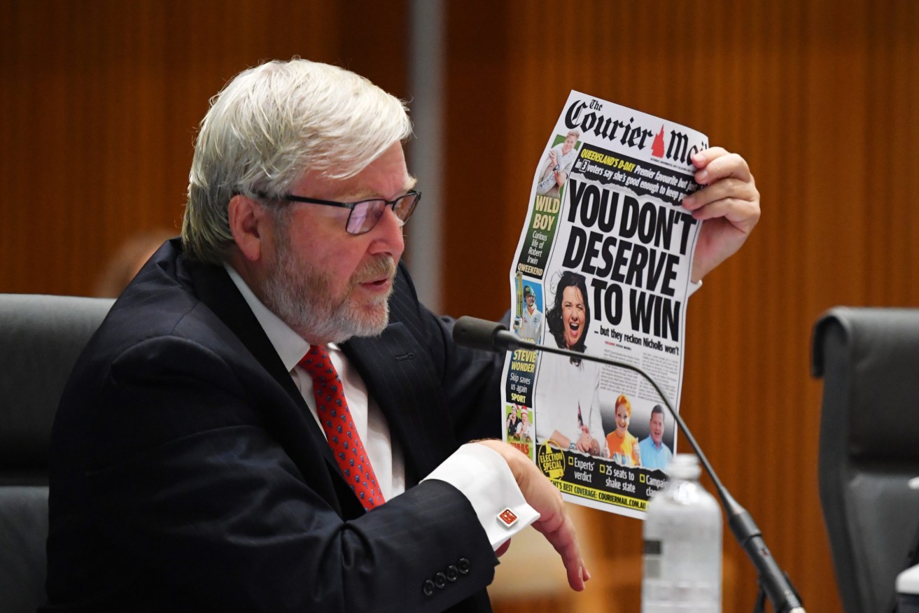 Former prime minister Kevin Rudd holds up a News Corp front page at the Senate inquiry into media diversity in Australia. Photo: AAP/Mick Tsikas