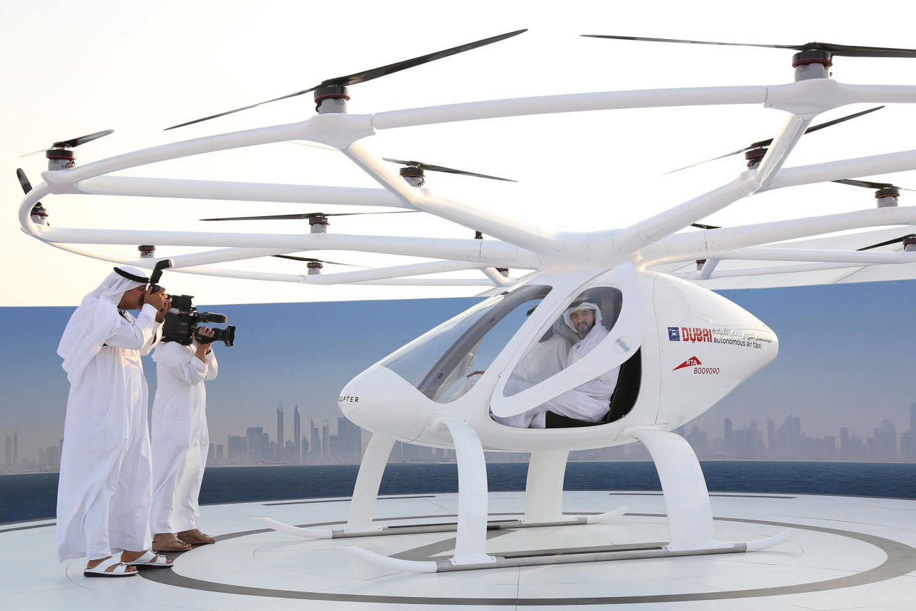Dubai's Crown Prince with a German-built flying taxi drone in 2017. Photo: Reuters/Satish Kumar