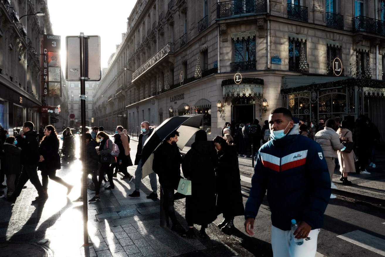 People walk down the Champs Elysees in Paris on Tuesday. Photo: AP/Thibault Camus