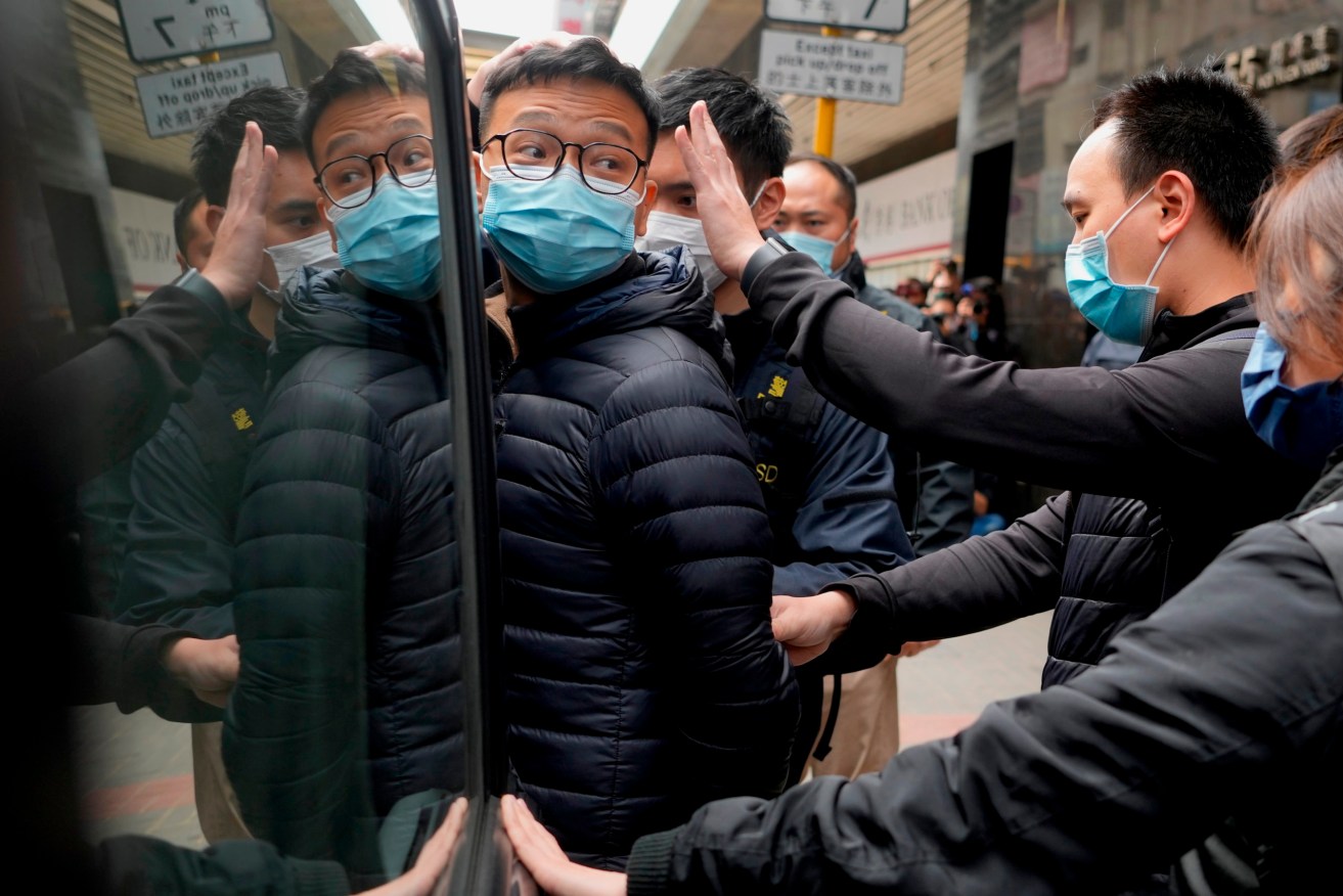 Editor of pro-democracy Stand News Patrick Lam, is taken by police. Photo: AP/Vincent Yu