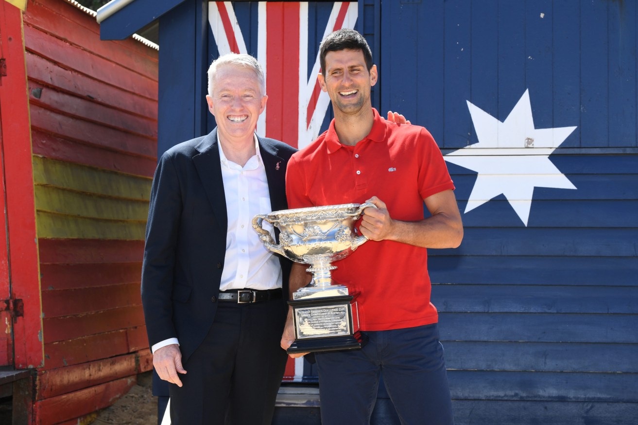 Novak Djokovic poses for photographs with Australian Open Tournament Director Craig Tiley (left) on Brighton Beach after winning last year's Australian Open (AAP Image/Dave Hunt). 