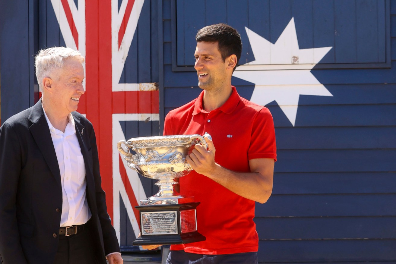 Novak Djokovic stands with Australian Open director Craig Tiley for a trophy photo shoot following his win at the Australian Open last year (AP Photo/Hamish Blair). 