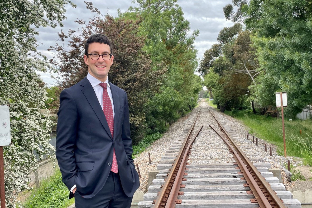 Independent MP Dan Cregan poses beside the rail line in Mount Barker, which Infrastructure SA has rejected as a solution to ease congestion on the South Eastern Freeway.  