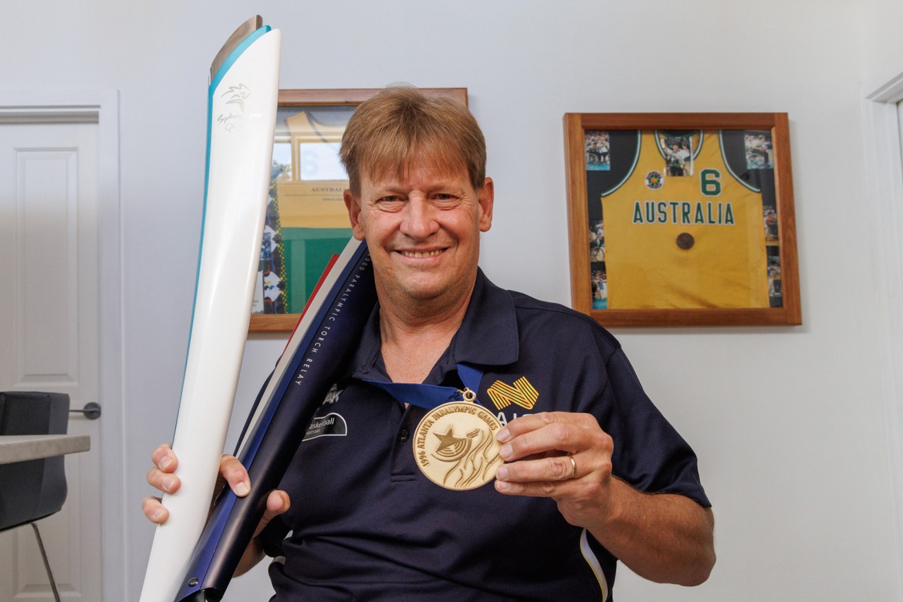David Gould, proudly displaying his 1996 Paralympic gold medal and Sydney Olympic and Paralympic torches, is the fourth inductee into the Hall of Fame this year. Photo: Tony Lewis/InDaily. 