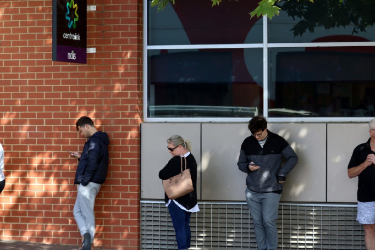 Today's December unemployment figures are in stark contrast with April 2020 when people queued outside the Norwood Centrelink office after losing their jobs. Picture: Kelly Barnes/AAP.