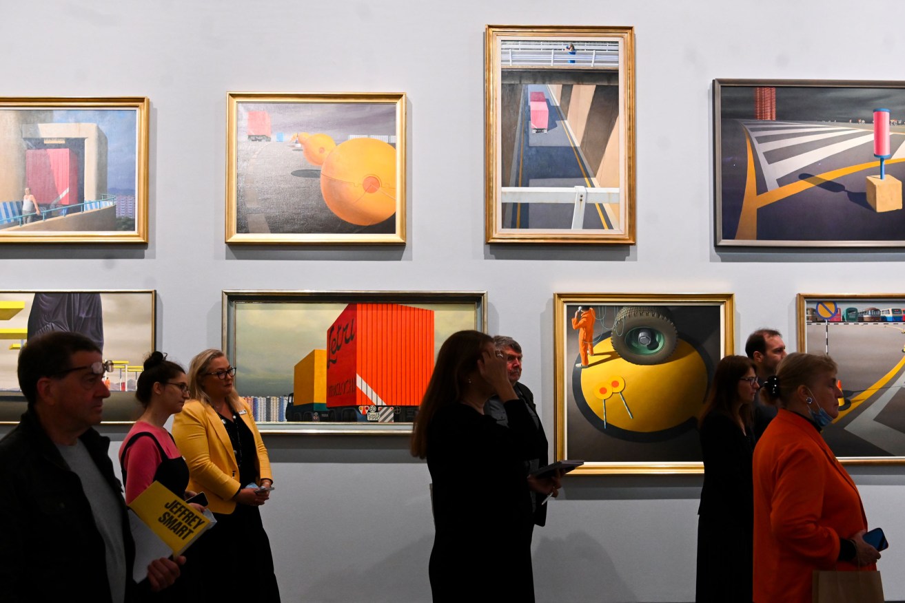Visitors look at artwork during a media preview of the Jeffrey Smart exhibition at the National Gallery  in Canberra. Photo: Lukas Coch / AAP