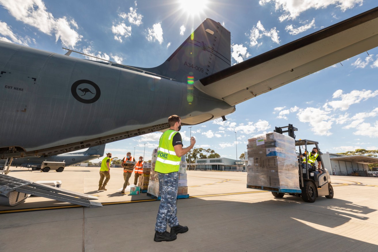 An RAAF crew loads supplies for cut-off Coober Pedy. Photo: Stewart Gould/Department of Defence 