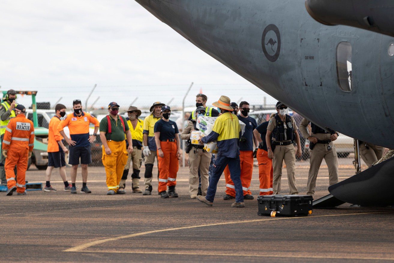 The RAAF's C-27J Spartan transport aircraft delivering food supplies at Coober Pedy airport on Monday. (Image: Supplied by The Department of Defence/Jarrod Mulvihill)