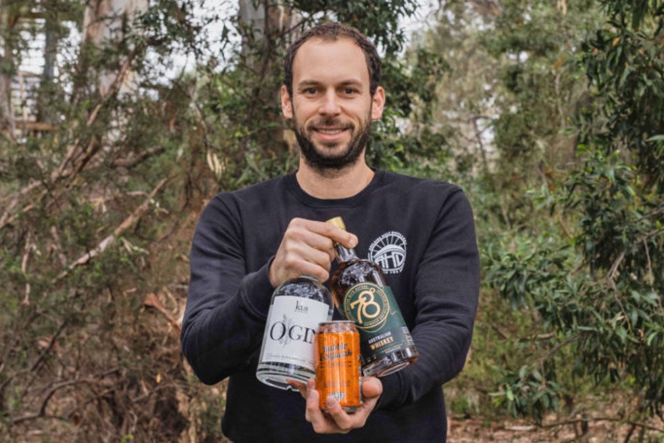 Adelaide Hills Distillery founder Sacha La Forgia with Mighty Craft products including his 78 Degrees Australian Whisky.