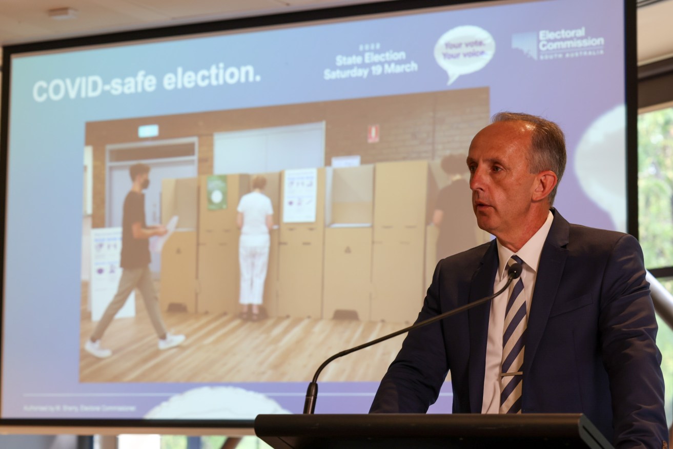 Electoral Commissioner Mick Sherry demonstrates a COVID-safe polling booth today. Photo: Tony Lewis / InDaily