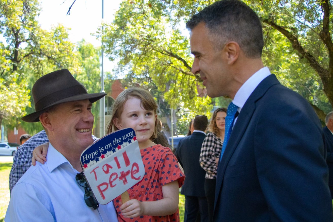 Nick Champion and his daughter greet 'Tall Pete' Malinauskas on the hustings. Photo: Twitter