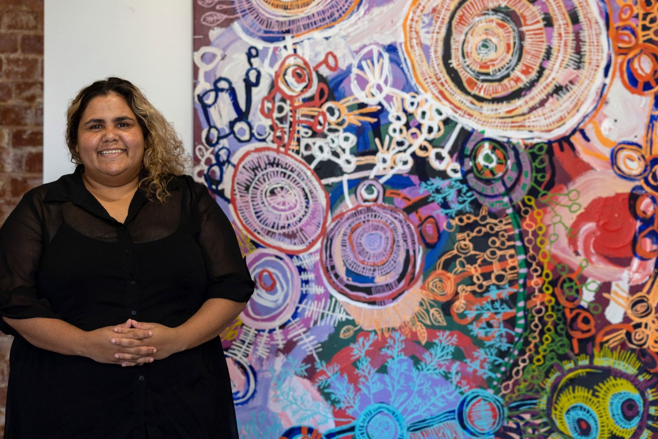 Sally Scales with one of the works in her first exhibition at APY Gallery in Adelaide last year. Photo: Tony Lewis