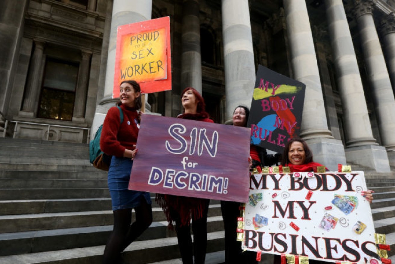 (L-R) Sex industry advocates Georgia Thain, Jodie Wells and Dominique Kohoron protesting outside SA Parliament two years ago ahead of the last failed bid to decriminalise sex work in 2019. Photo: Kelly Barnes/AAP 