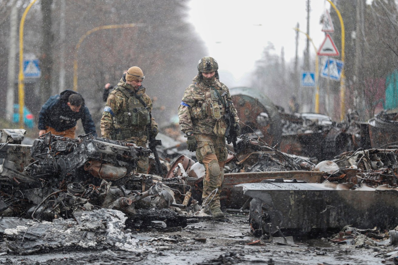 Ukrainian Soldiers inspect destroyed Russian military machinery in the city of Bucha, Ukraine. Photo: Atef Safadi/EPA