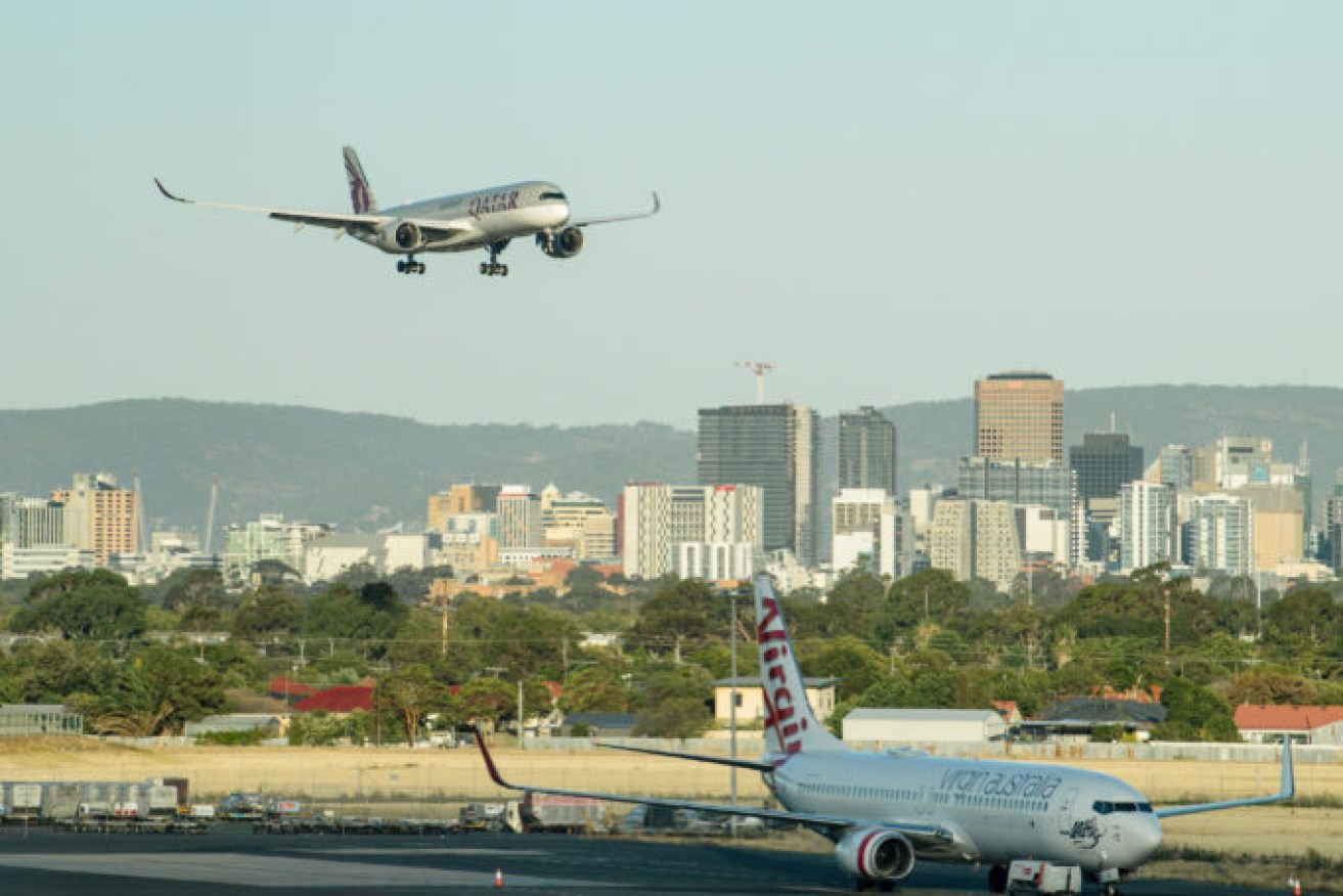 A Qatar Airways flight lands in Adelaide. Photo: AAP/Morgan Sette