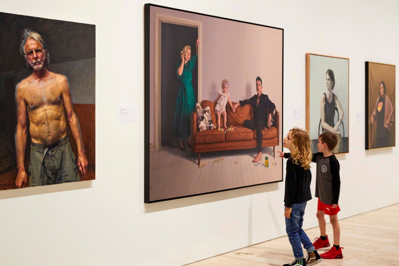 Children view the 2022 Archibald Prize exhibition at the Art Gallery of NSW, including (foreground) Robert Hannaford's self-portrait and (far right) Tsering Hannaford's painting of Sally Scales. Also pictured are portraits by Jonathan Dalton and Keith Burt. Photo:  Felicity Jenkins / ©AGNSW