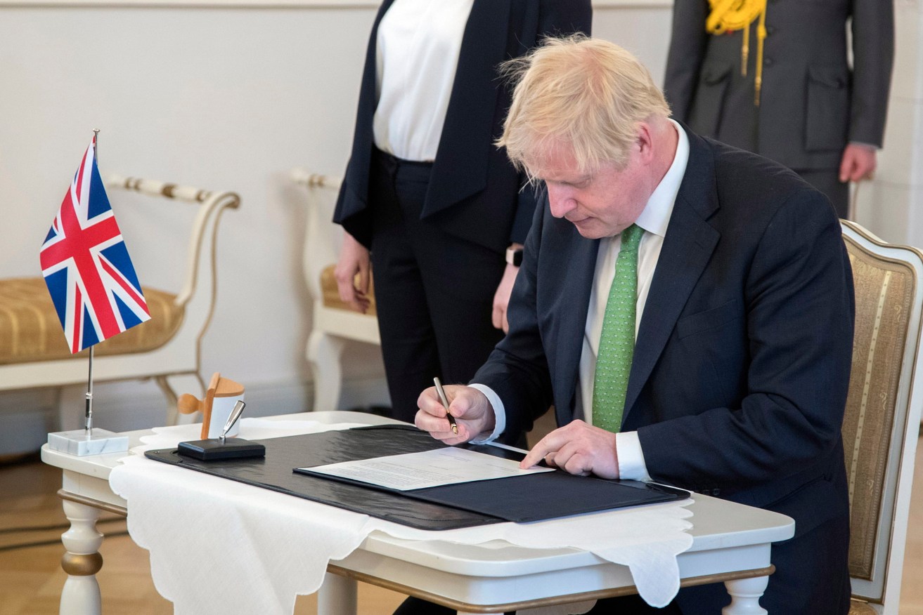 British Prime Minister Boris Johnson signs a UK-Finland security pact in Helsinki this week. Photo: EPA/MAURI RATILAINEN