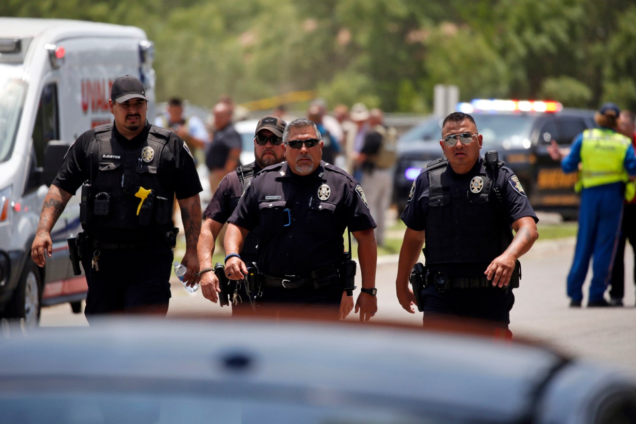 Police walk near Robb Elementary School following the May 24 shootingin Uvalde, Texas. Photo: Dario Lopez-Mills/AP