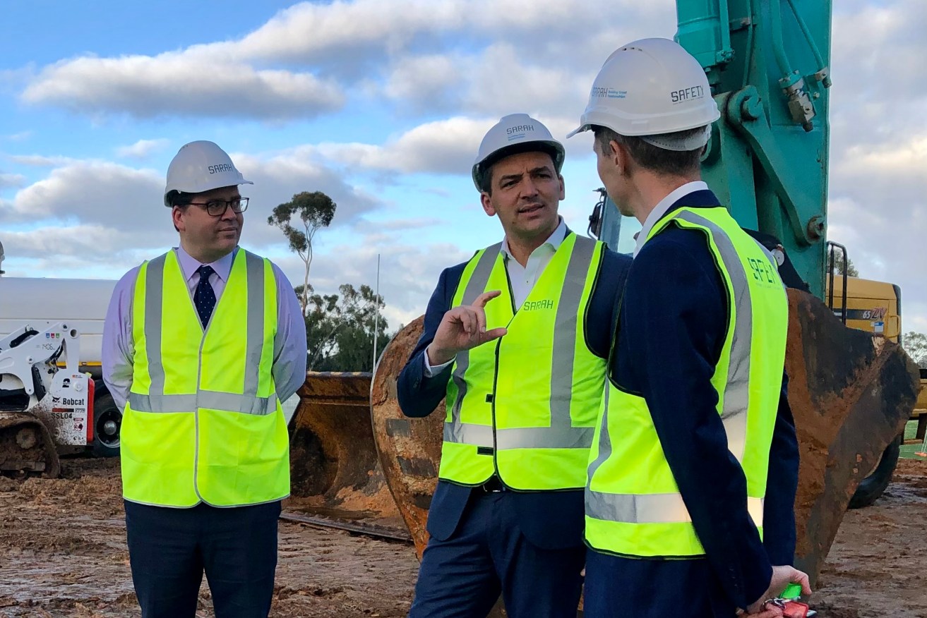 Education Minister Blair Boyer (centre) chats to Morialta Secondary College principal Roley Coulter, watched by former education minister John Gardner during a visit to the school's construction site this week. Photo: Jemma Chapman/InDaily