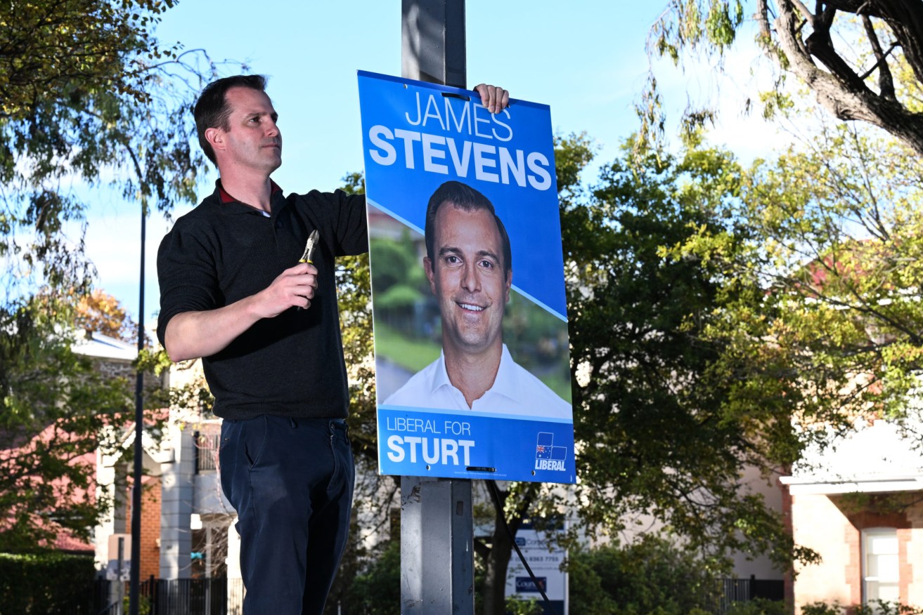 Sturt MP James Stevens removes election signage in his seat. Photo: Michael Errey / InDaily