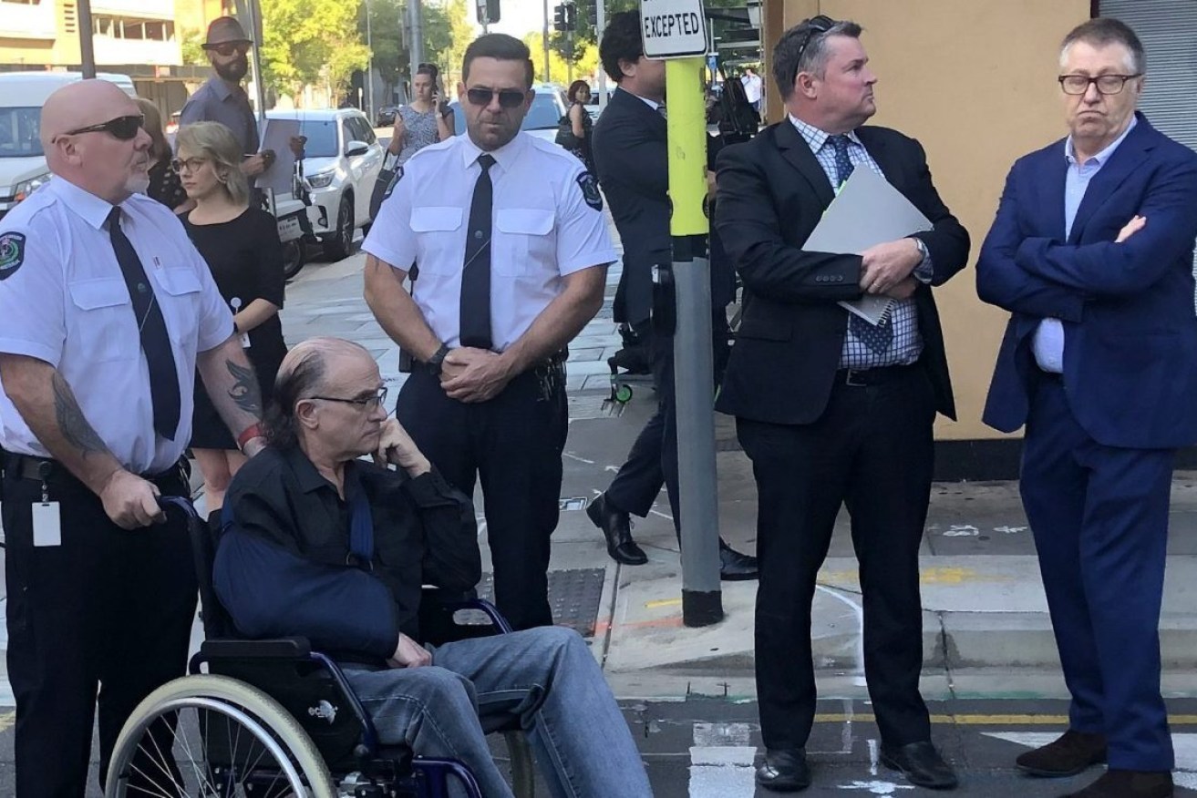 Domenic Perre (seated) visits Adelaide sites as part of the trial which found him guilty of the National Crime Authority bombing. Photo: AAP/Ten News First, Kate Somers