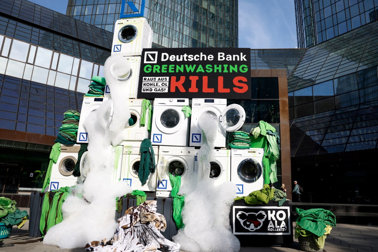 A protest outside  Deutsche Bank's May 19 shareholders meeting in Frankfurt, Germany. On June 1, the bank was raided by 50 police officers over insider claims regarding the truth about ESG credentials of managed assets worth hundreds of billions $US, and their role in marketing for ethical investment funds. The bank's asset arm chief executive has resigned. Photo: Reuters/Heiko Becker