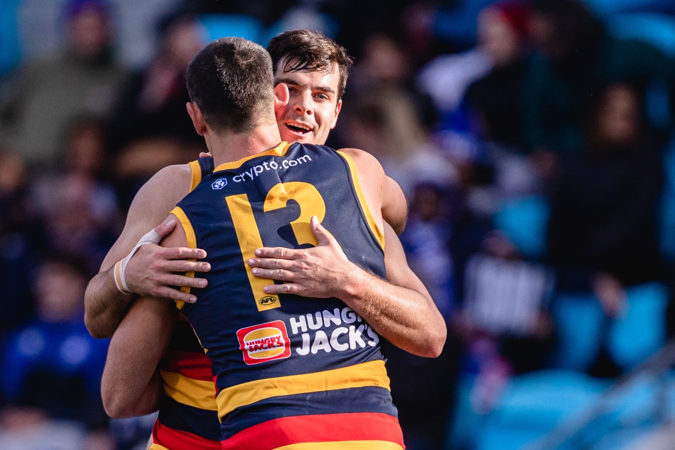 Fog and Tex share an embrace as the pair kick 10 goals between them against North Melbourne. Ideally Fog manages that on his own at some point soonish. Photo: Linda Higginson / AAP