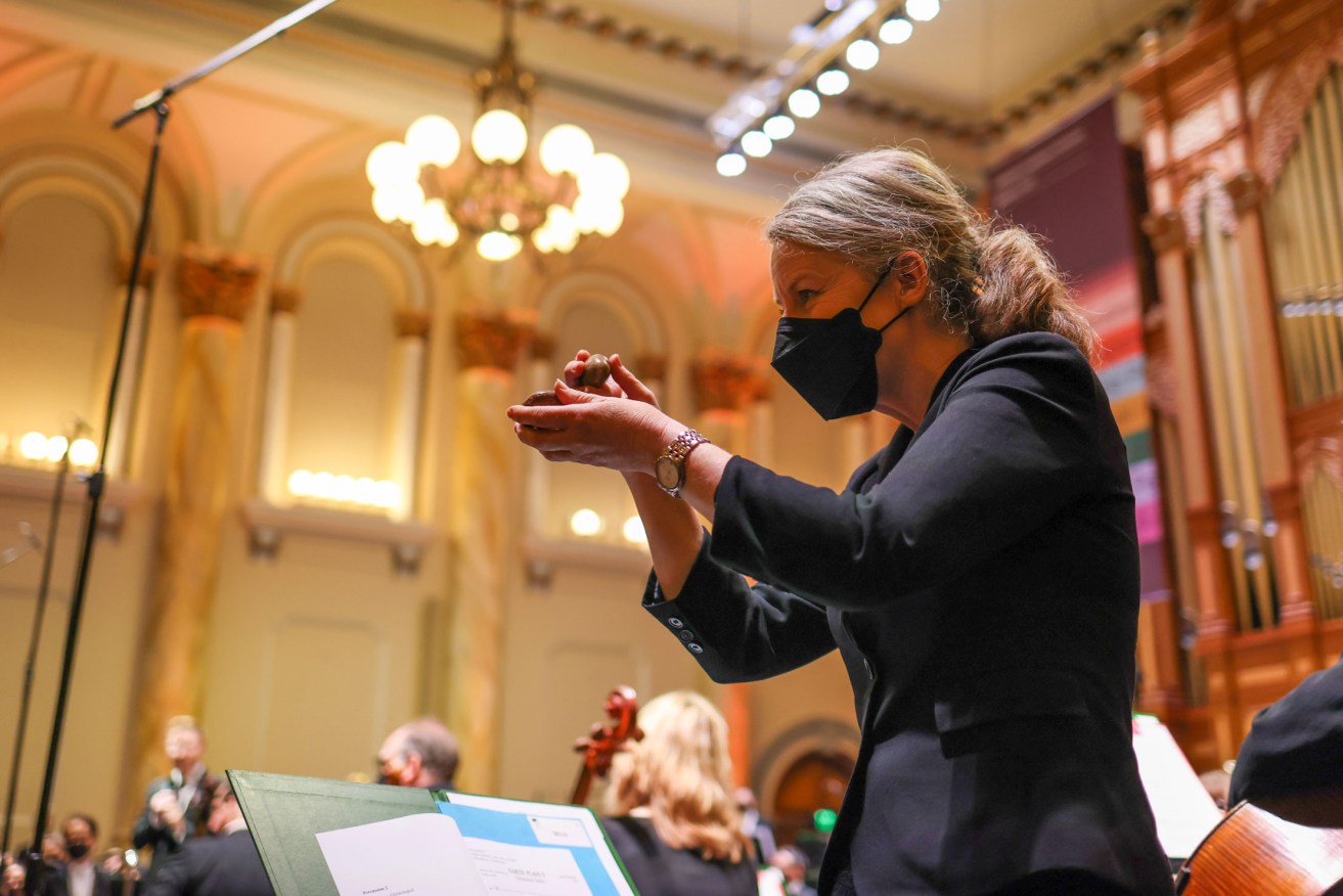 Serenity: Percussion player Amanda Grigg plays river stones, which were also given to 100 audience members to tap on queue in Cathy Milliken’s 'Ediacaran Fields'. Photo: Tony Lewis