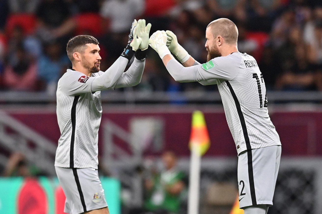 Australia's goalkeeper and captain Mathew Ryan (left) is replaced by teammate Andrew Redmayne for the penalty shootout against Peru. Photo: Noushad Thekkayil/EPA