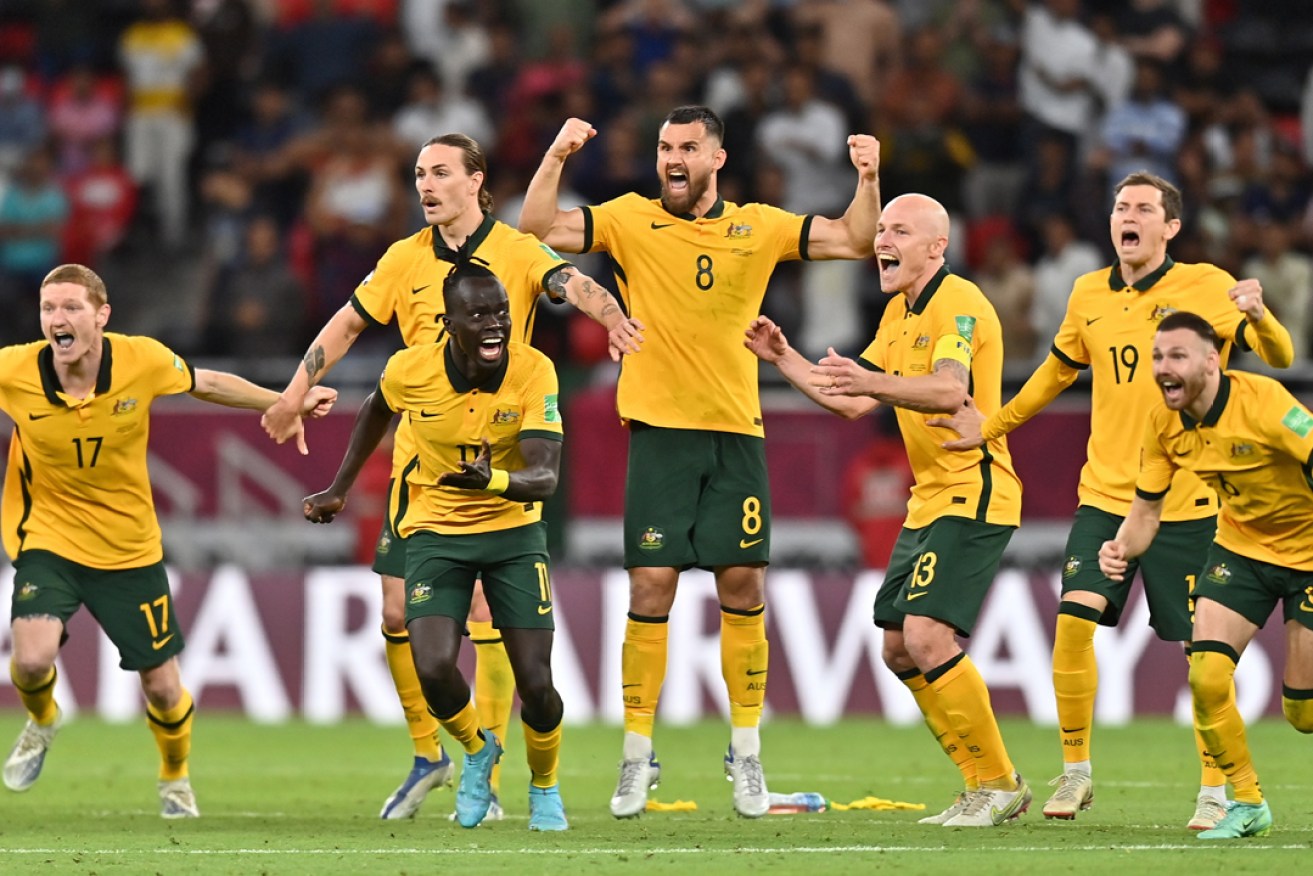 Australian players celebrate a dramatic penalty shootout win over Peru to qualify for the FIFA World Cup 2022.  Photo: Noushad Thekkayil/EPA.