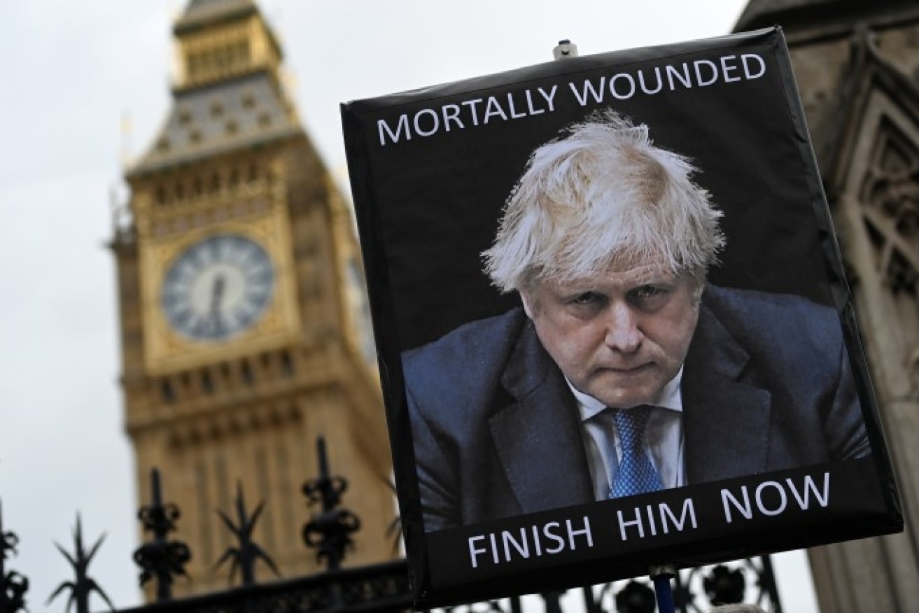 A billboard outside the British parliament before Boris Johnson's resignation this month.  Photo: Andy Rain/EPA