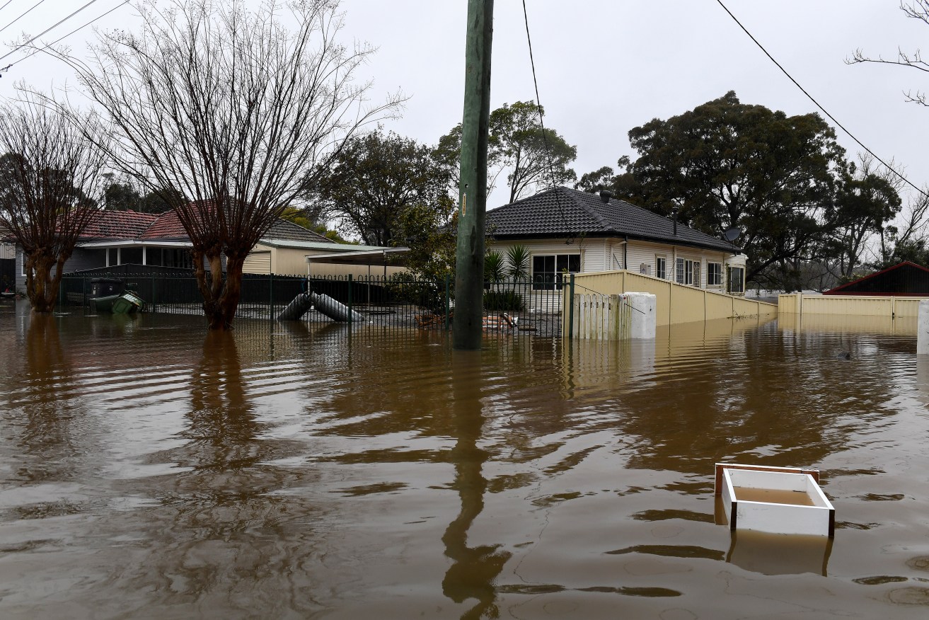 Properties and roads were yesterday submerged under floodwater from the swollen Hawkesbury River in Windsor, north west of Sydney. Photo: Bianca De Marchi / AAP