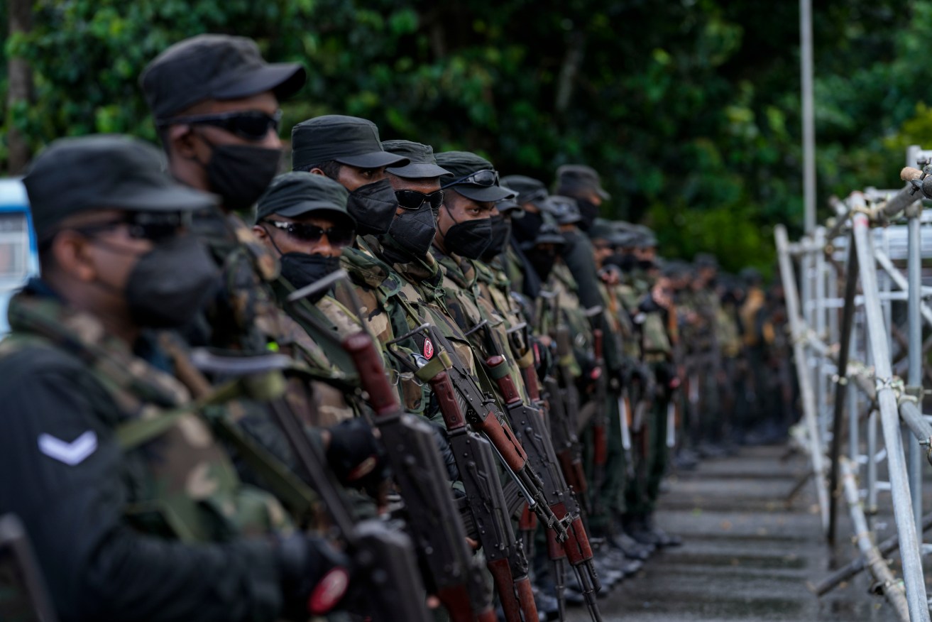 Soldiers stands guard outside the parliament building in Colombo. Photo: AP/Rafiq Maqbool