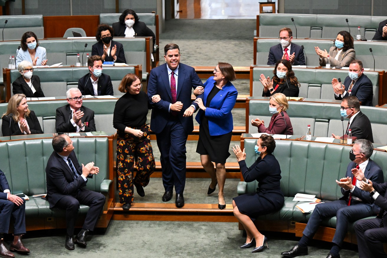 New House of Representatives Speaker Milton Dick is dragged to the chair during the opening of the 47th Federal Parliament on Tuesday. Photo: AAP/Lukas Coch