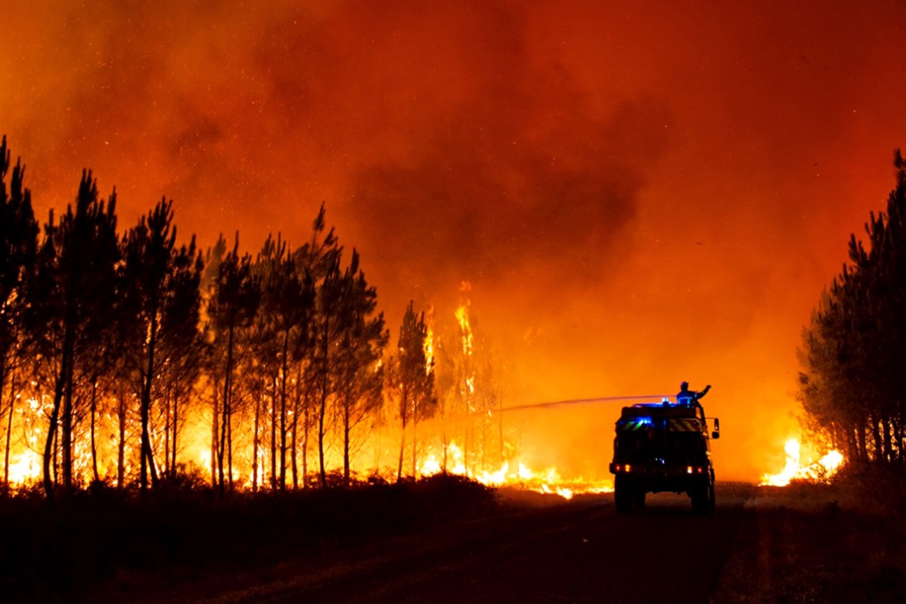 Firefighters battle a blaze at Belin-Beliet, in the Gironde region of southwestern France. Photo supplied
