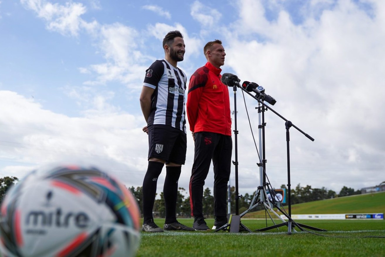  Adelaide City's Nicholas Bucco and Adelaide United's Lachlan Barr. Photo: Adelaide United