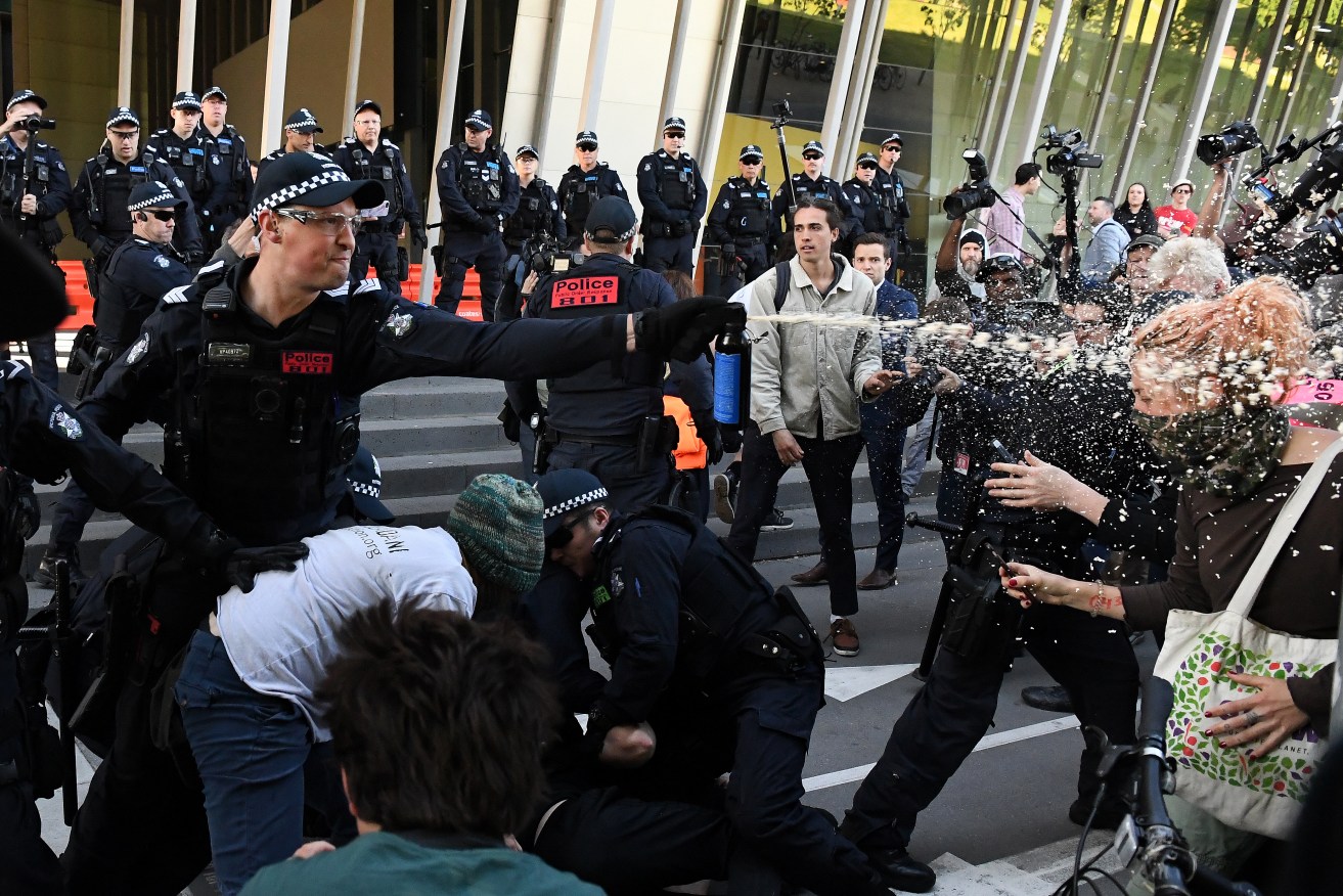 Victoria Police capsicum spray protesters outside a Melbourne mining conference in 2019. Photo: AAP/James Ross