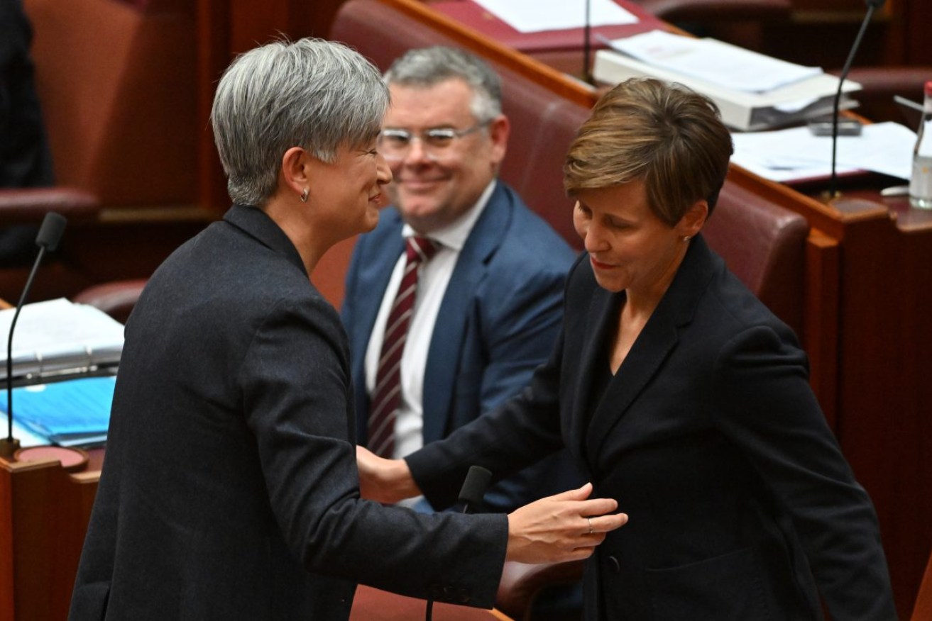 Foreign Affairs Minister Penny Wong and Assistant Minister for Climate Change Jenny McAllister embrace after Labor's Climate Change Bill passed the Senate on Thursday. Photo: AAP/Mick Tsikas