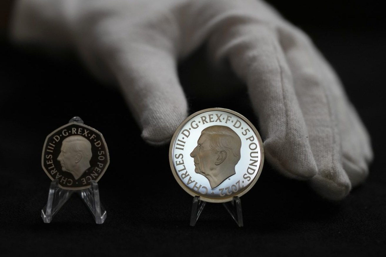 Two new coins bearing official coinage portrait of King Charles III: on the left is the new 50 pence coin, and right is the new 5 pound commemorative coin. Photo: AP/Alastair Grant