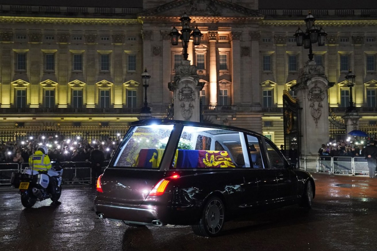 The hearse carrying the coffin of Queen Elizabeth II arrives at Buckingham Palace, London, where it will lie at rest overnight in the Bow Room. Photo: Gareth Fuller/PA Wire
