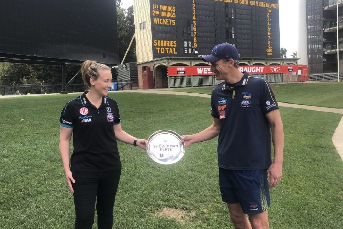 Port Adelaide coach Lauren Arnell and Crows coach Matthew Clarke meet before the historic first AFLW Showdown. Photo: Michelangelo Rucci