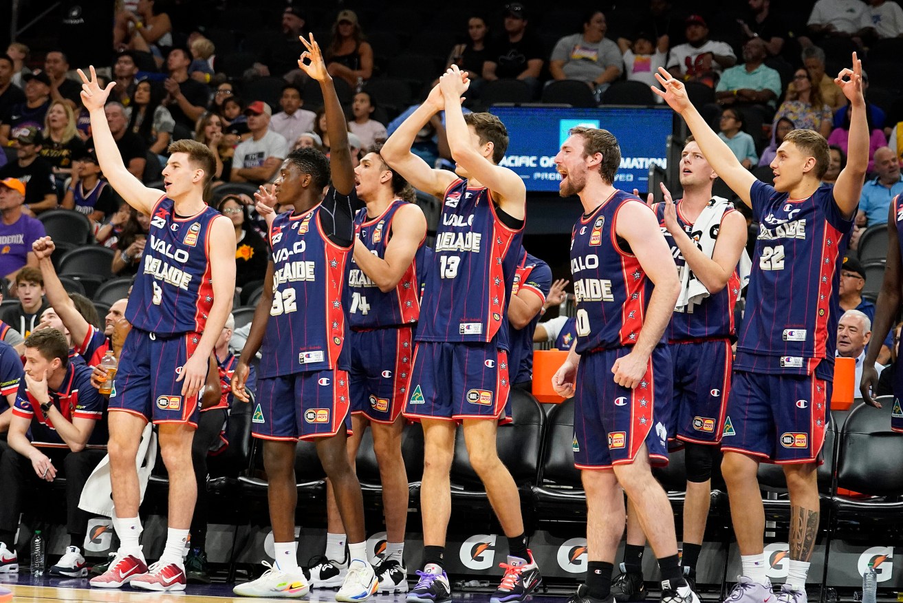 Adelaide 36ers bench players celebrate a lead on the Phoenix Suns during the first half of their upset win against Phoenix. Photo: AP/Darryl Webb.